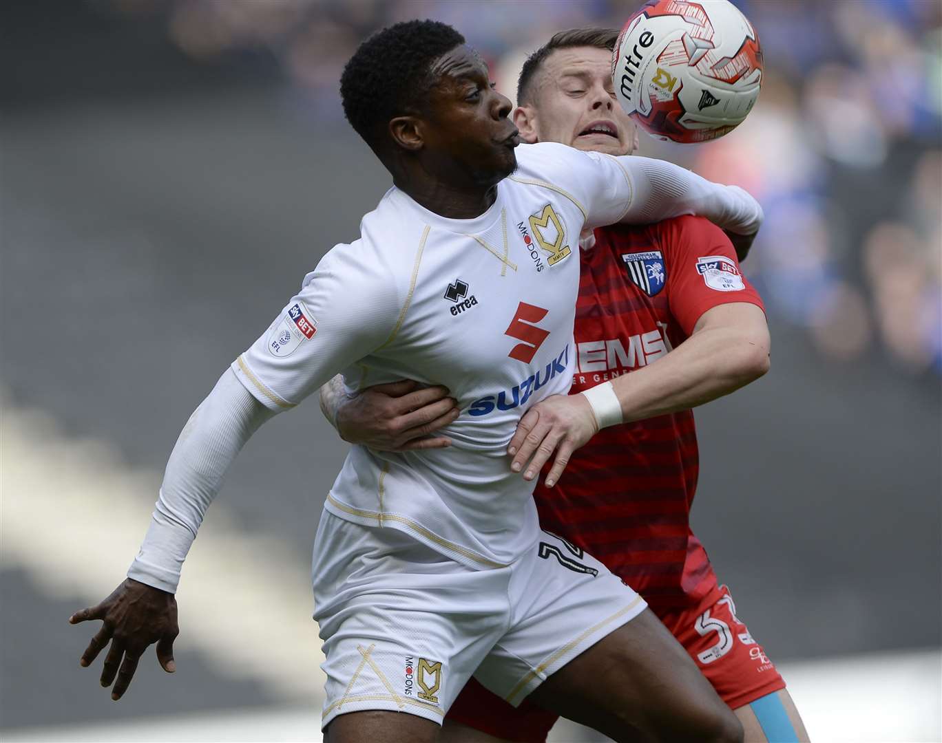 Gillingham’s Mark Byrne loses out to Kieran Agard during their game with MK Dons Picture: Ady Kerry