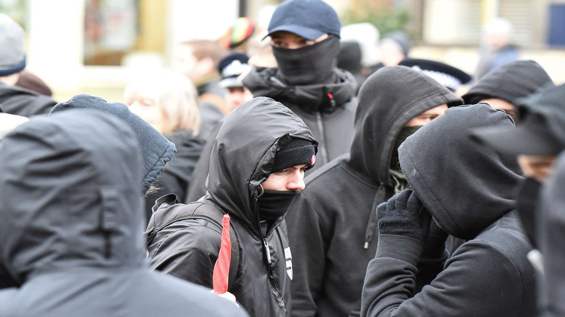 The sinister masked men at the anti-racism rally just before the riots erupted.