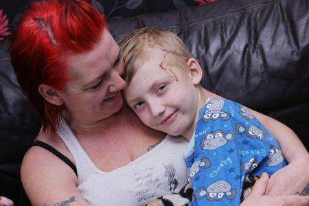 Jackie Pye cuddles her son, Luke, 10, after he was hit by a car in Maidstone