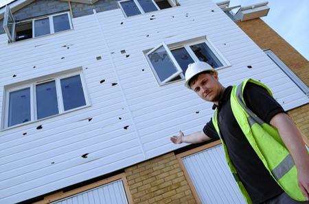 Apprentice electrician Lewis Hopkins shows the smashed fascia and window units