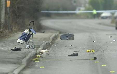 TRAGIC SCENE: Joyce Denning's shopping trolley, flowers and shoes in the road after the collision. Picture: GRANT FALVEY