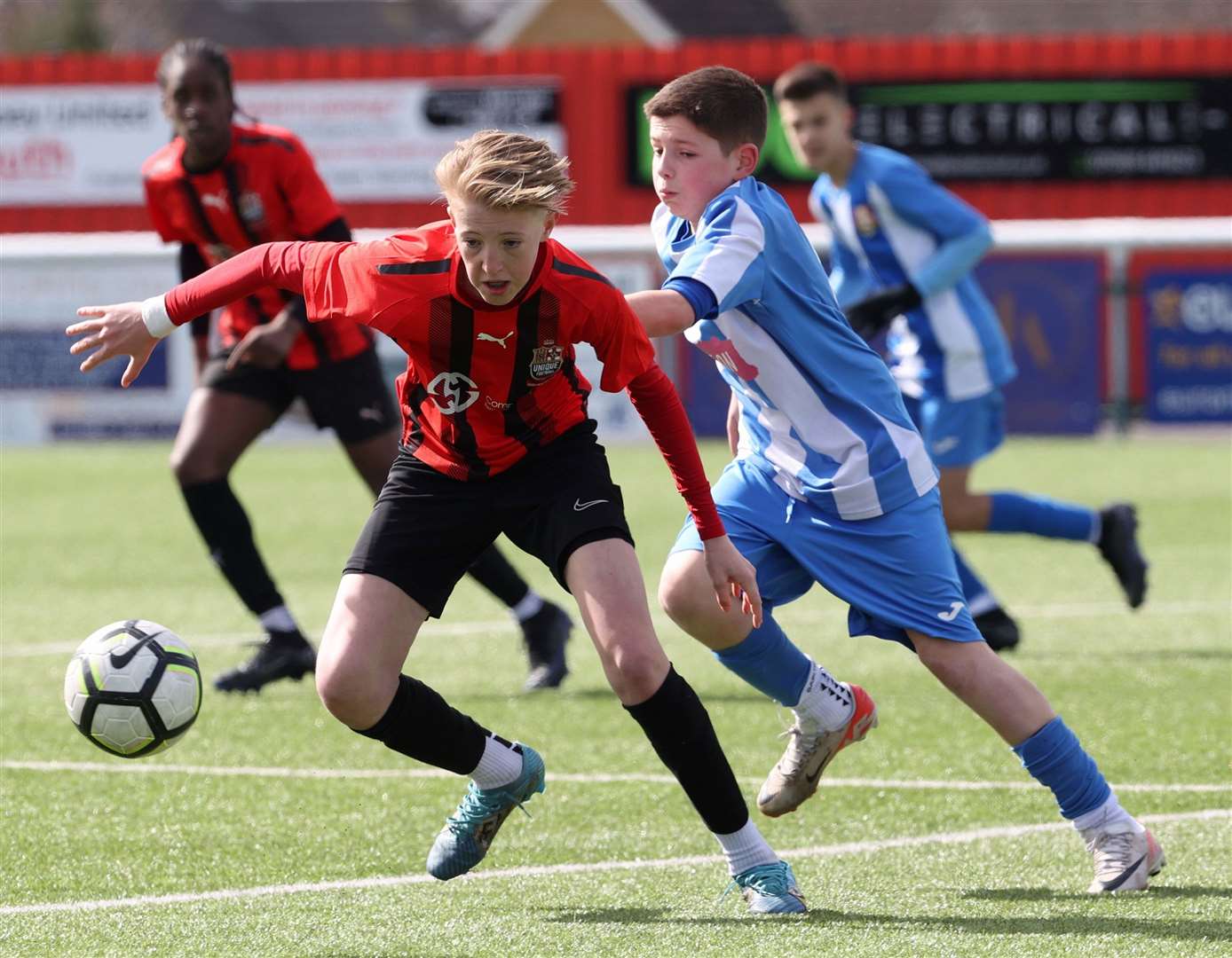 Action from the Kent Merit Under-13 Boys Cup Final between.Metrogas (blue) and Unique Football Academy. Picture: PSP Images