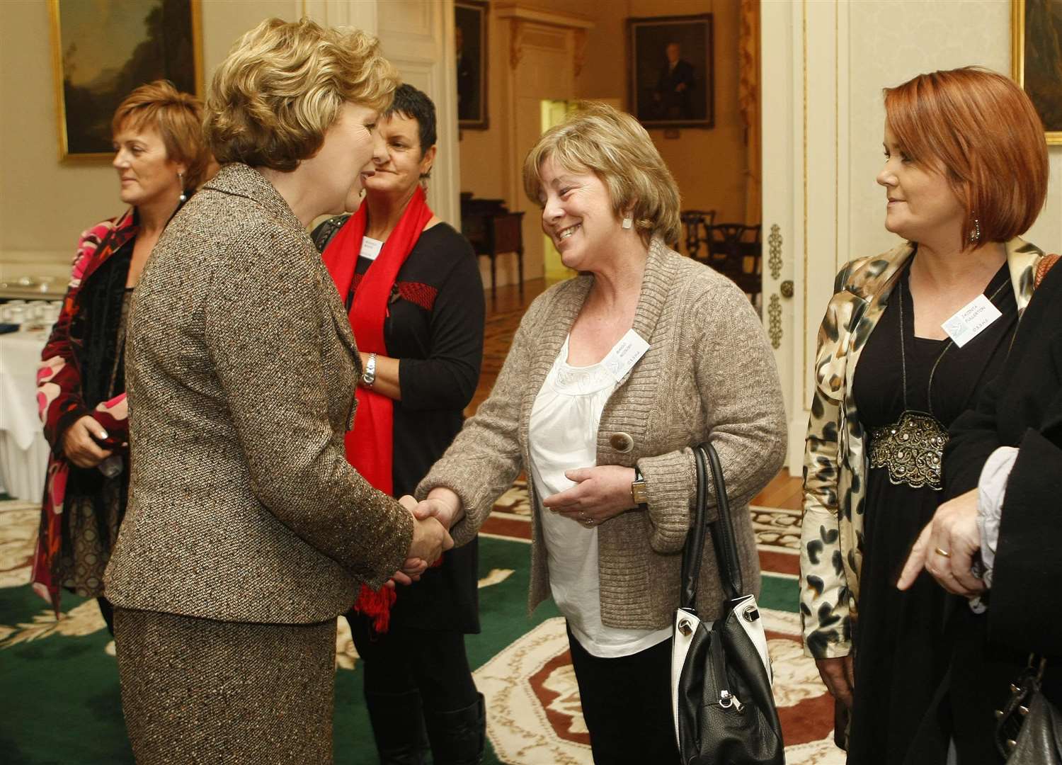 President Mary McAleese speaks in 2010 to Margo McCrory whose son was injured during the Omagh bombing (PA)