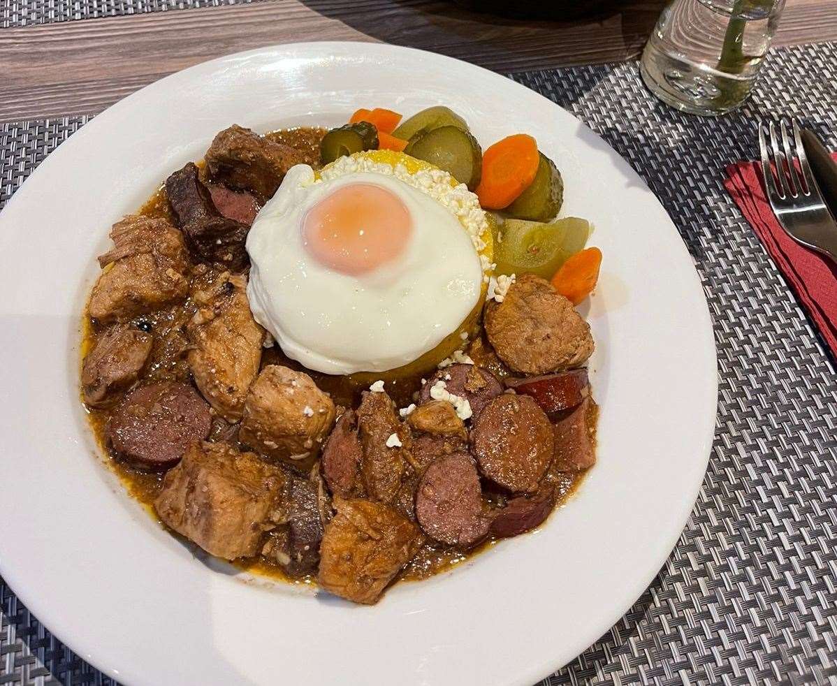 Pork meat, liver and sausage stew in tomato sauce served with polenta, cheese and a fried egg . Picture: Vasile Conduraru