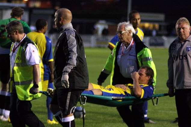 Simon King is carried off injured in a pre-season game at Bromley