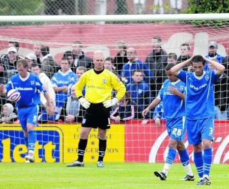 Gillingham's players look dejected after Exeter's third goal. Picture: Matthew Walker