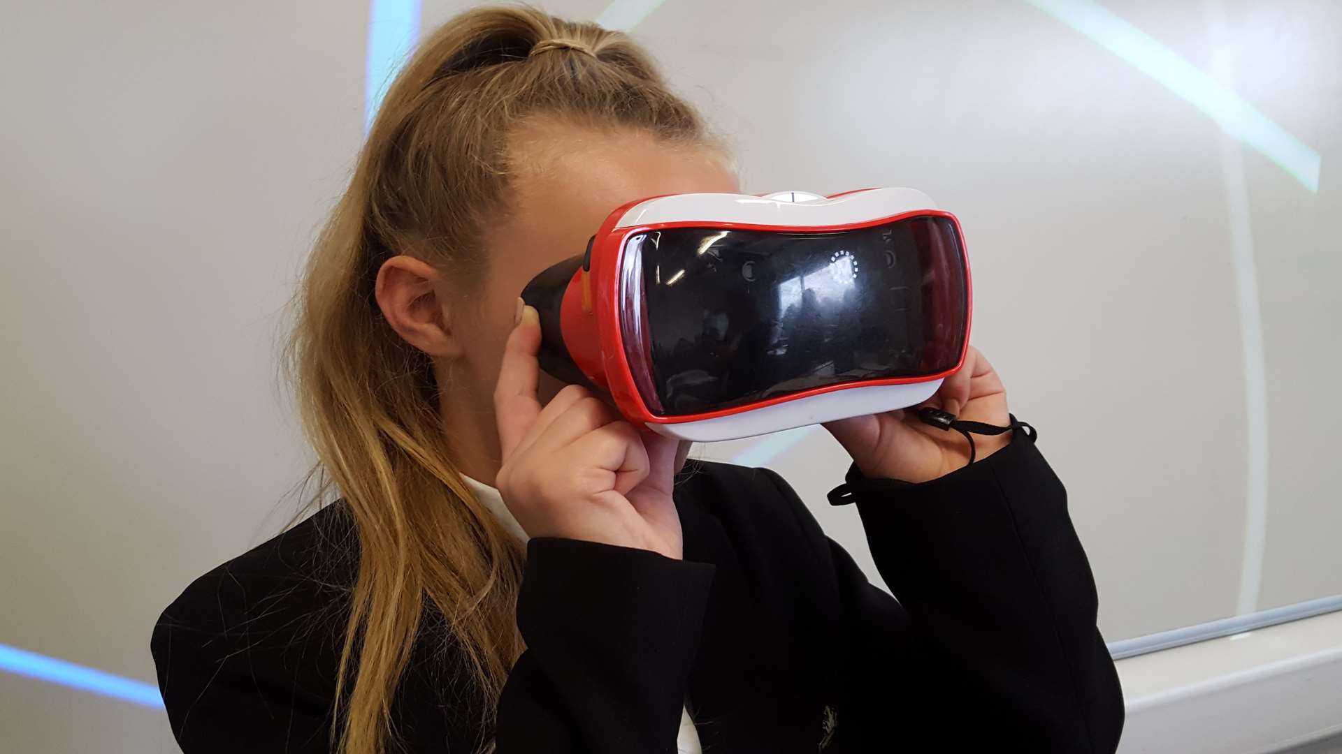 Erin Northover, 11, uses the virtual reality goggles look at images of skin cells while her teacher is discussing them