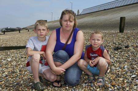 Stephanie Heaton, pictured with sons Jack Rogers, 10, left, and Connor Jones, six, is concerned about the amount of broken glass being left on the beach at Sheerness