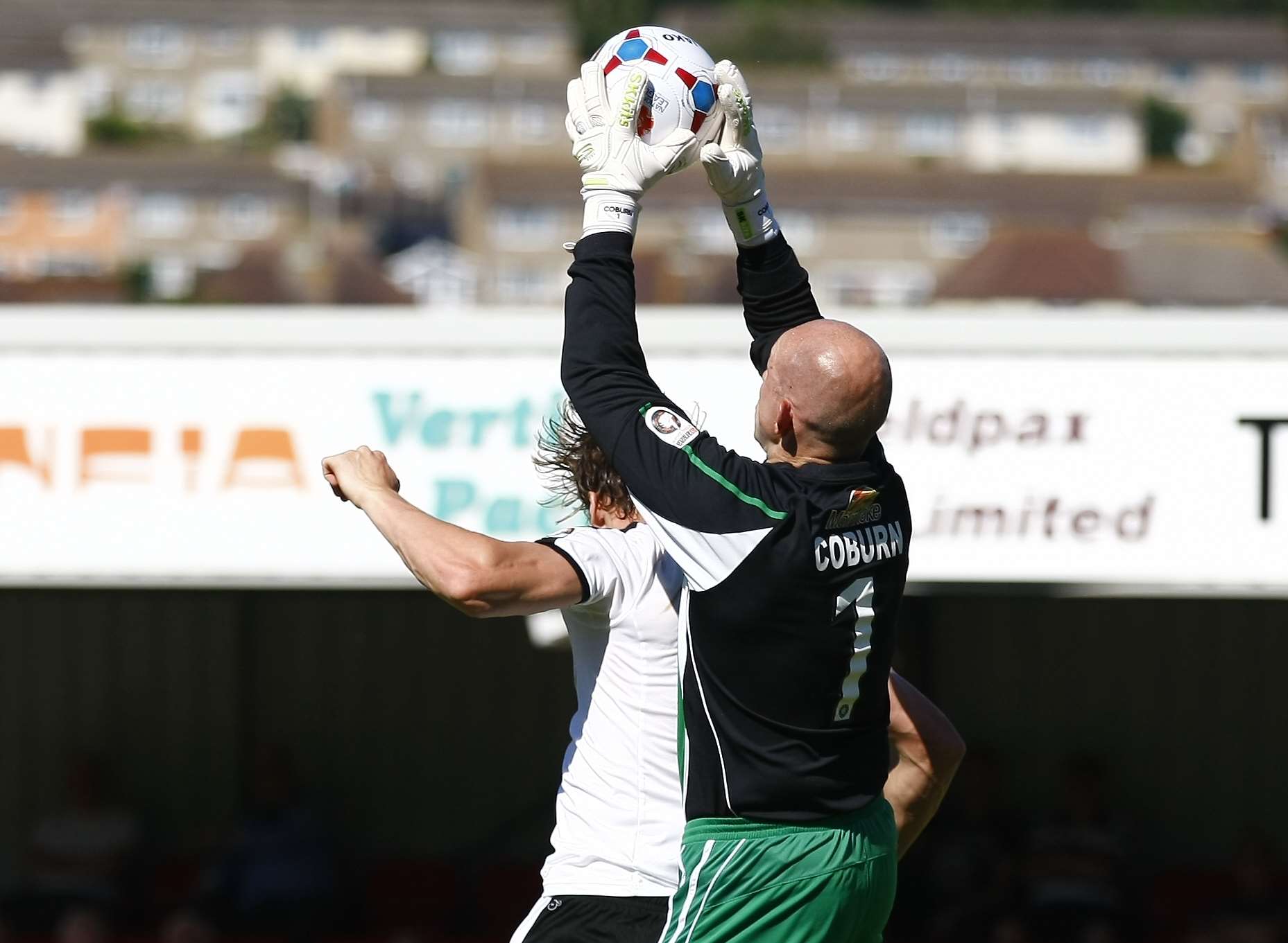 Sean Raggett challenges Altrincham goalkeeper Stuart Coburn Picture: Matt Bristow