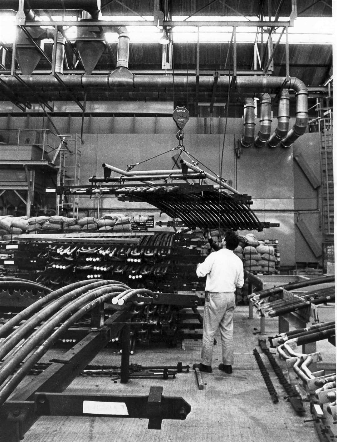 At Dungeness Power Station in October 1971, an operator lifts a boiler element to move it towards the cleaning machine for the removal of rust