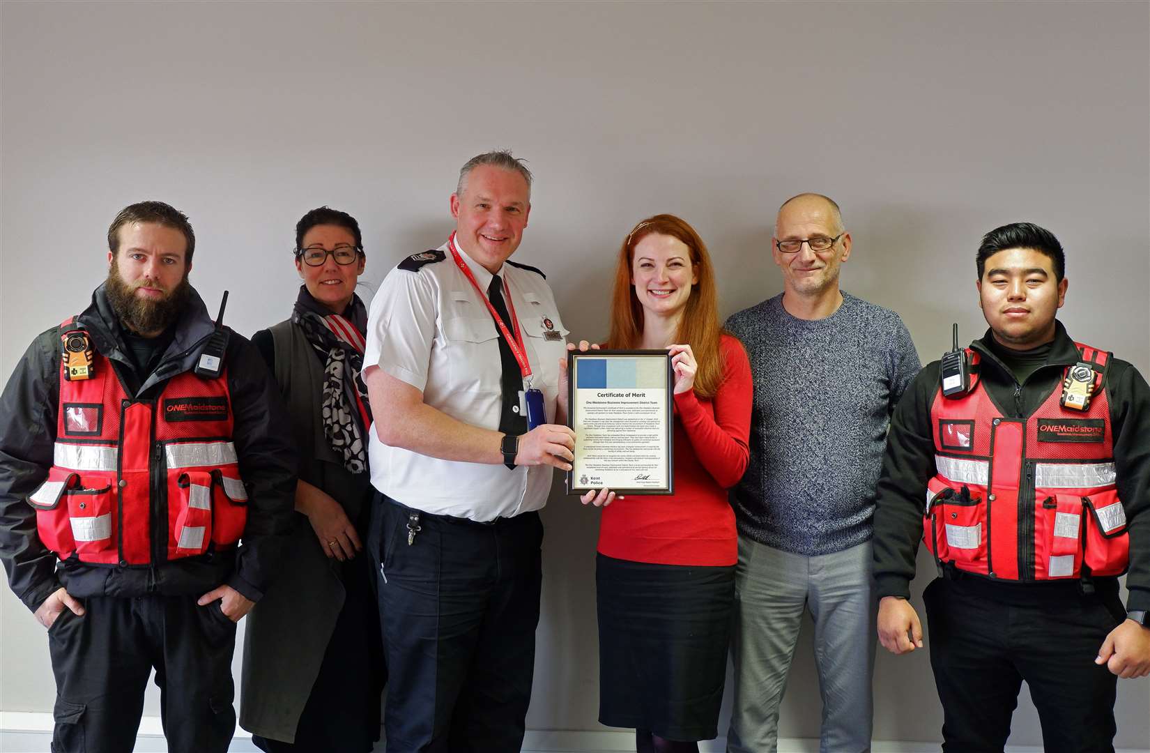 One Maidstone BID Manager Ilsa Butler, with BID Ambassadors and team, accepting the award from Sgt Andy Stringer of Kent Police. Picture: OneMaidstone