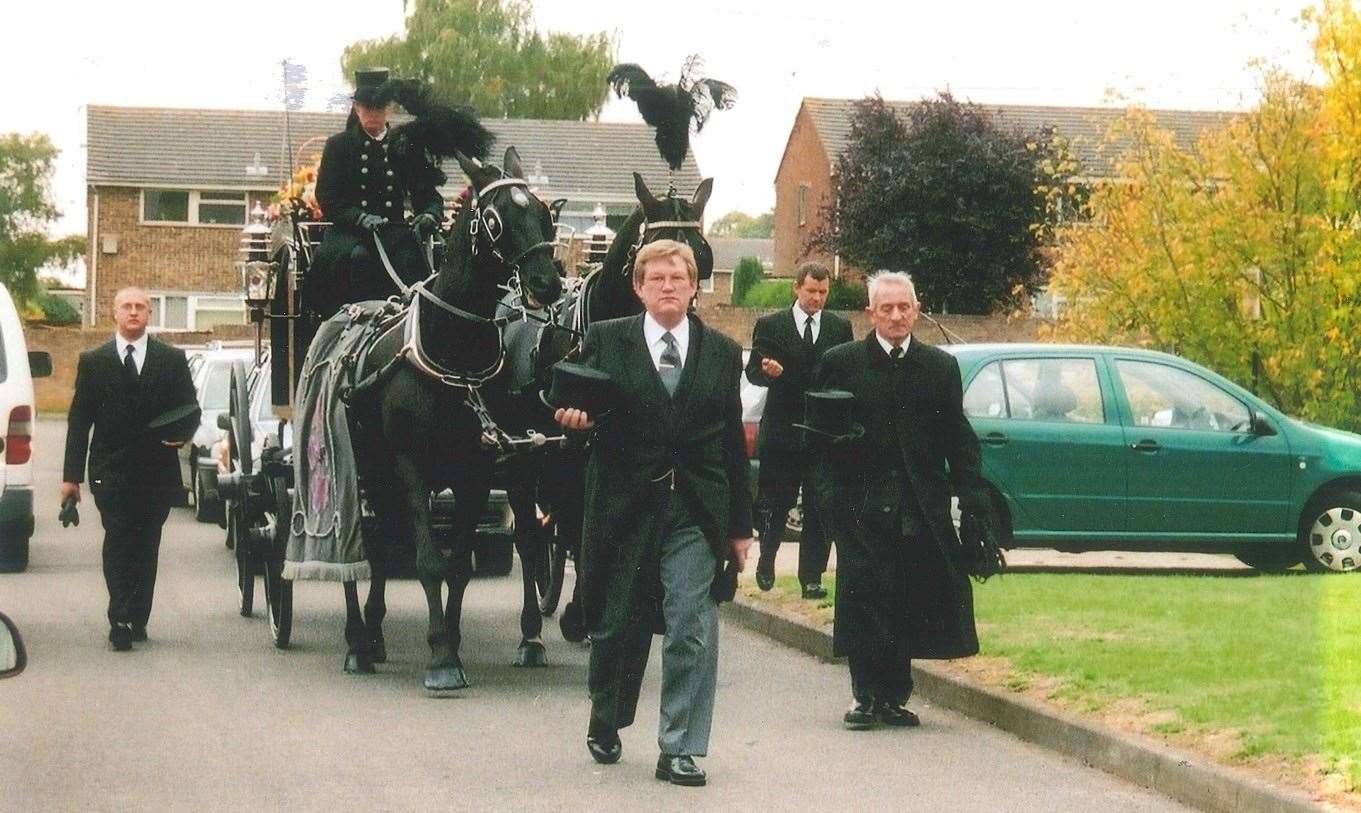 Medway funeral director Terry Allen leads the horse drawn carriage