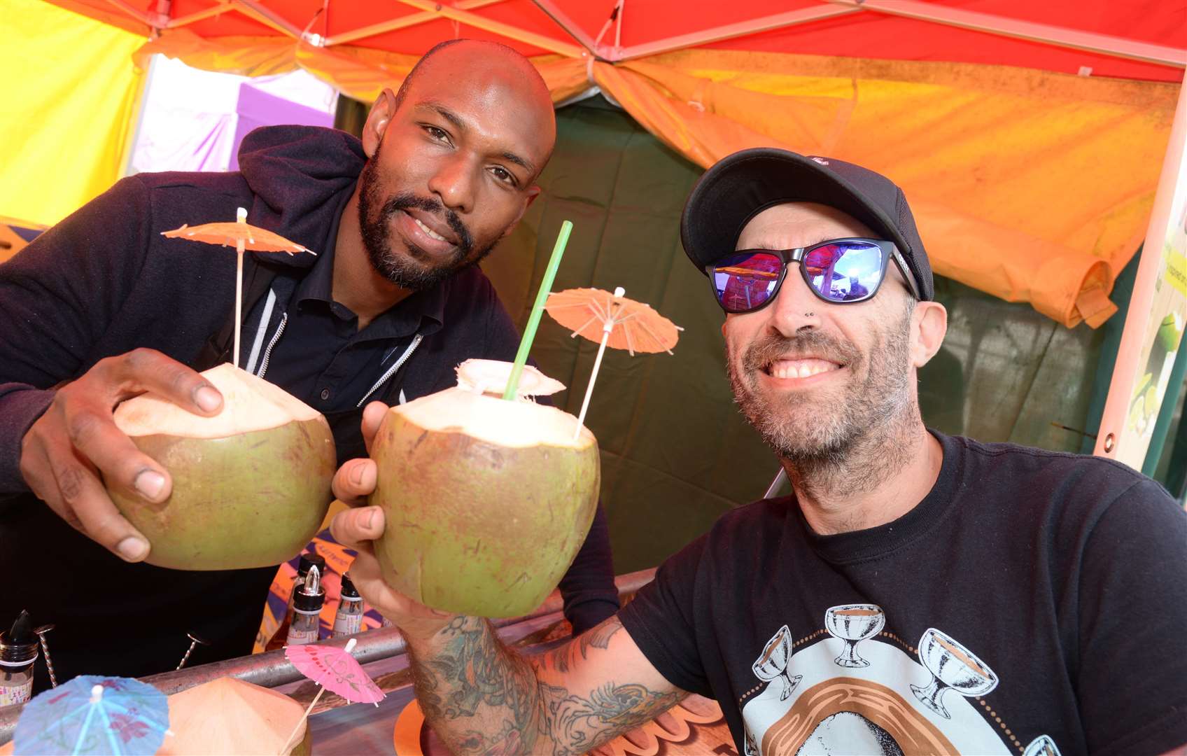 Lloydon Alleyne at the Tropical Coconut Shack serves up an exotic drink to Mark Henderson at last year's Shemomedjamo festival in Mote Park Picture: Chris Davey