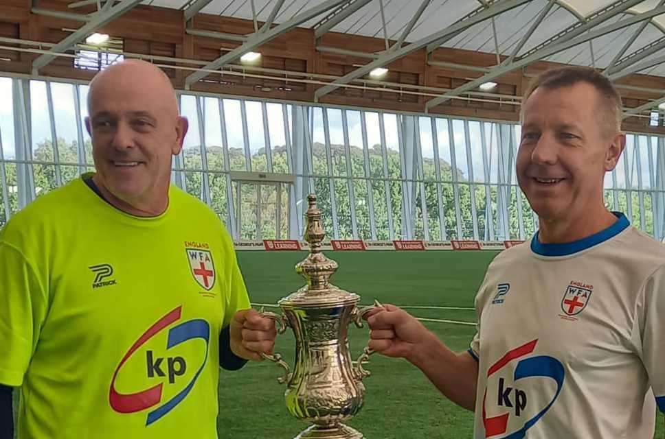 Gary Groom and goalkeeper Mickey Orme - the man who got him into walking football - with the World Nations Cup trophy together