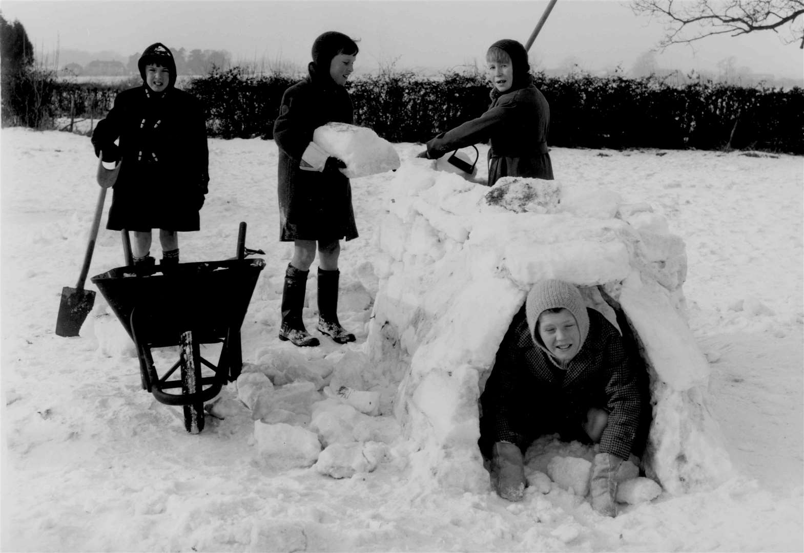Children build an igloo at Bossingham in January 1963