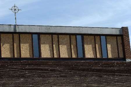 VANDALISED: The smashed windows at St Thomas More Catholic Church are boarded up. Picture: ANDY PAYTON