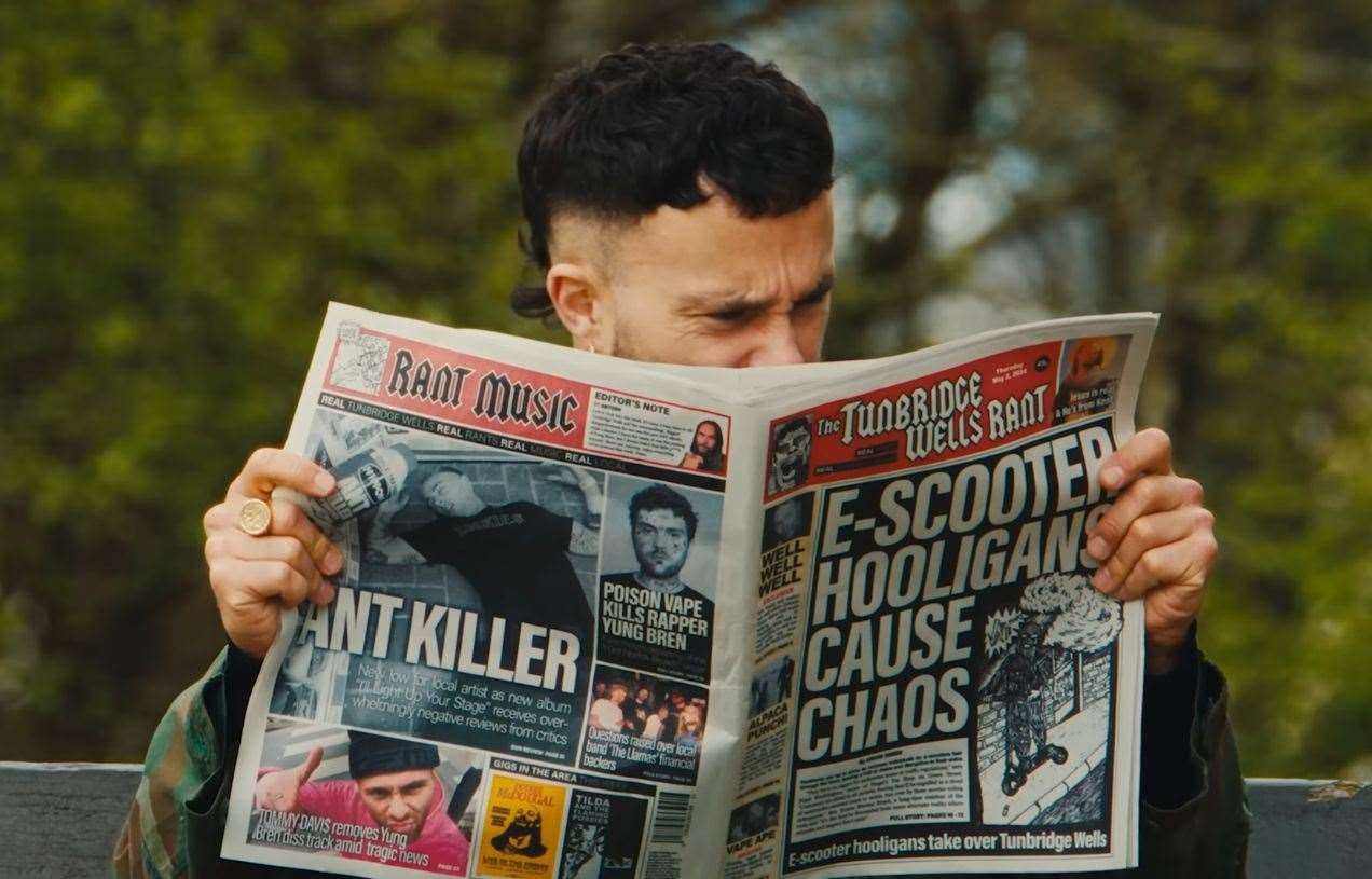 Isaac holds a mock newspaper in one of the shots. Picture: YouTube