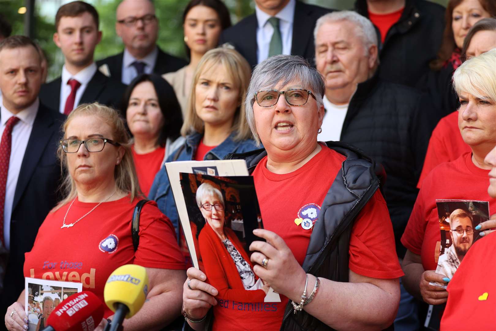 Brenda Doherty of Northern Ireland Covid-19 Bereaved Families for Justice holds a photo of her late mother Ruth Burke outside the Clayton Hotel in Belfast (Liam McBurney/PA)