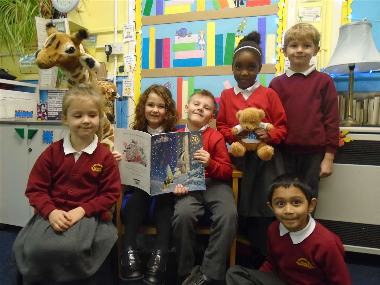 Children from Giraffe Class at St Peter's Infants, Rochester with their signed copy of One Snowy Night.