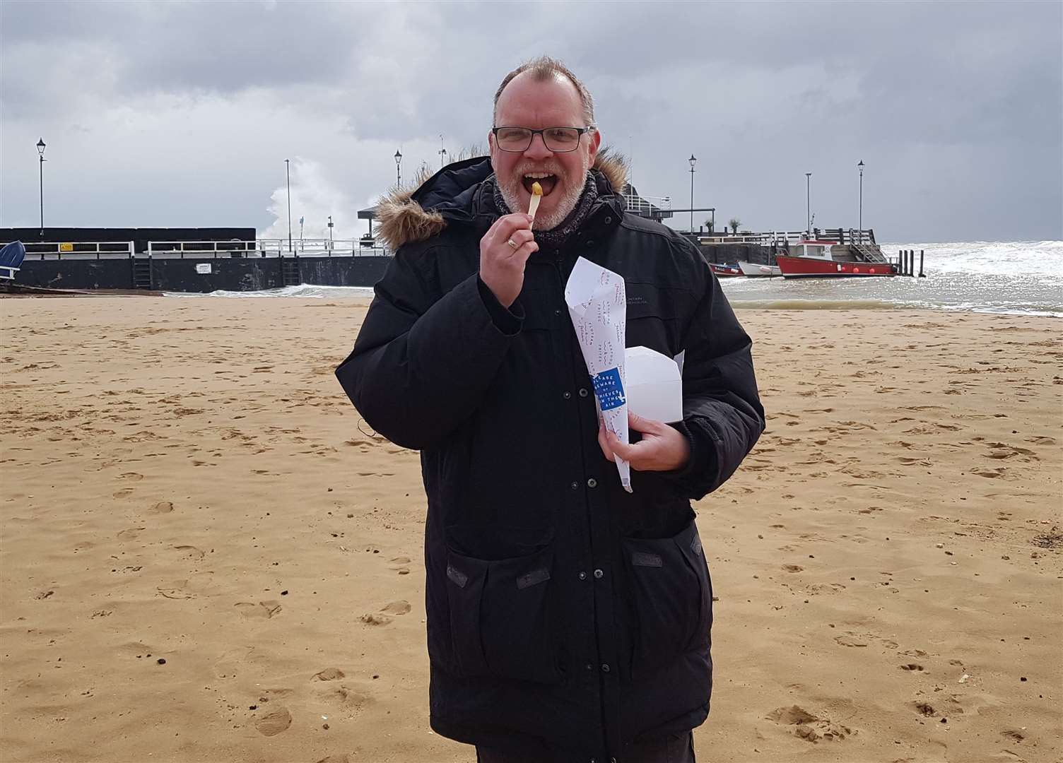 Your reviewer braves the elements (please note the waves break on the seawall behind) to eat fries