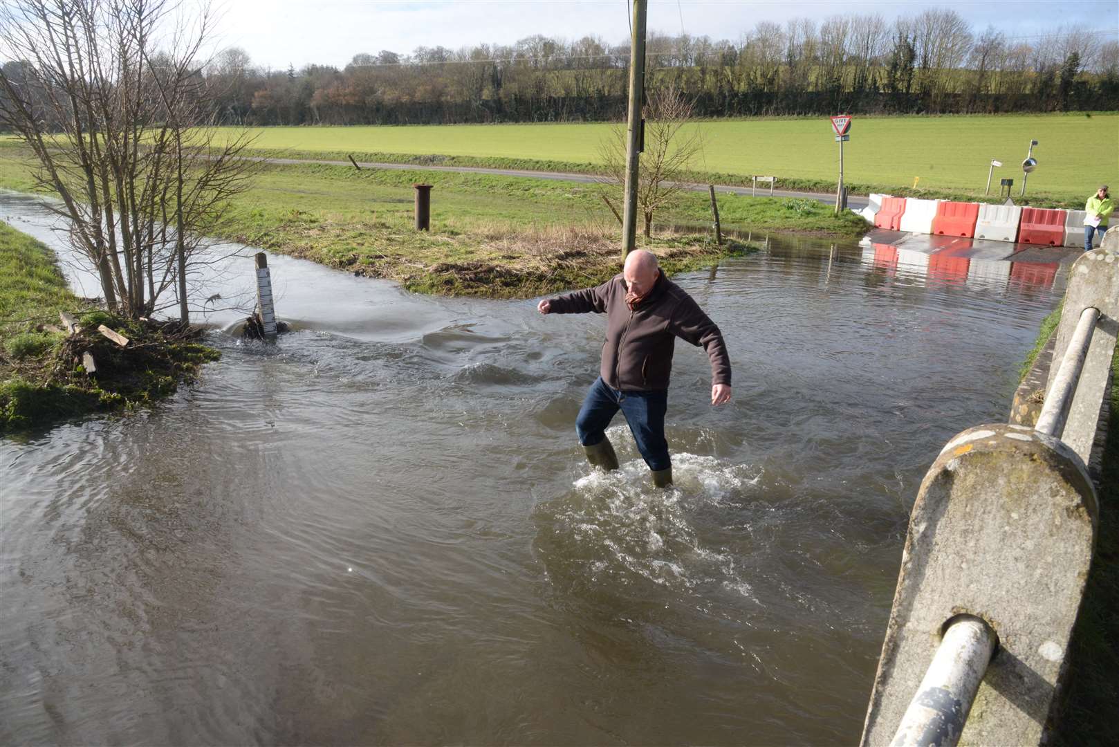 Cllr Mike Sole at the junction of Out Elmstead Lane and Valley Road, Barham, which has been flooded by the Nailbourne river. Picture: Chris Davey