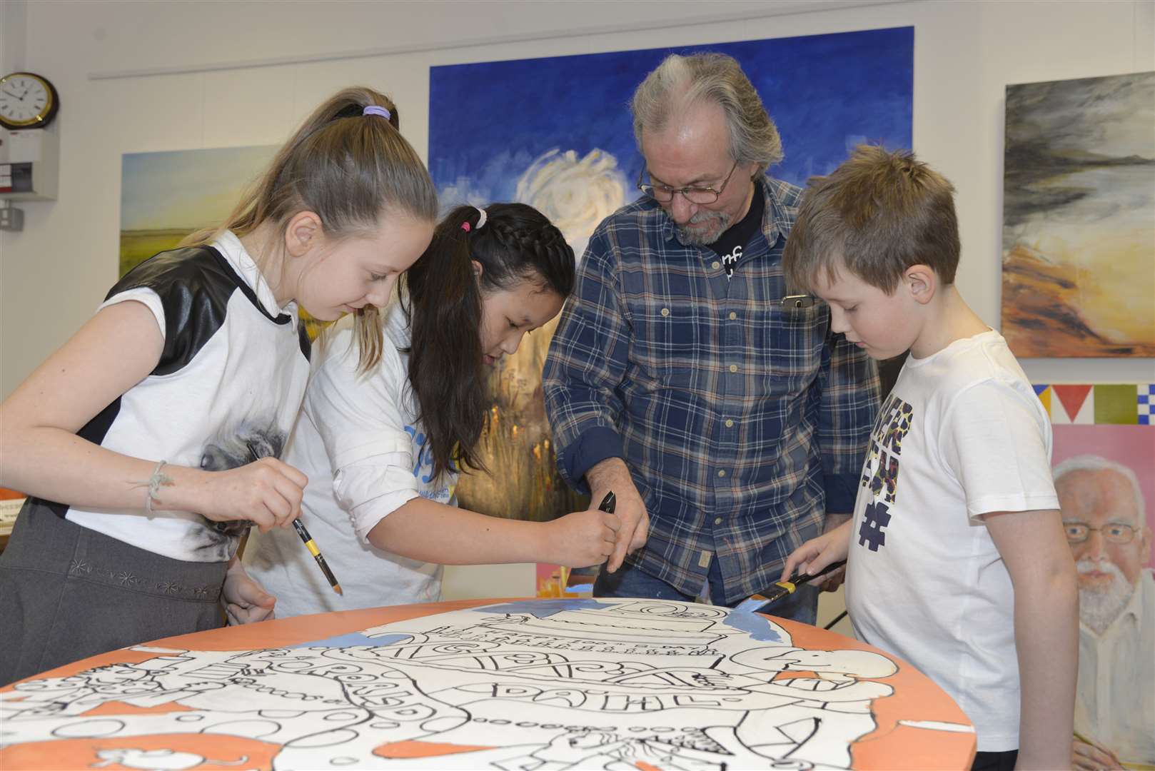 Marta, 10, Rejina 11, and Simon 8 from Oakfield Community Primary School take part with the help of Stephen Oliver.