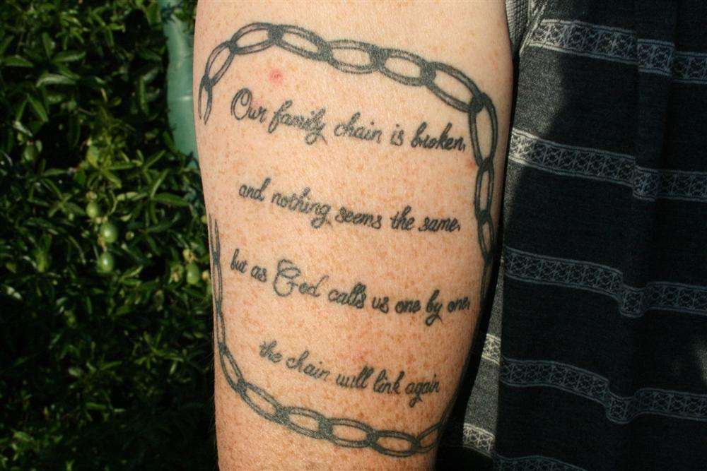 Dad Paul has a tattoo of a broken chain with words inside