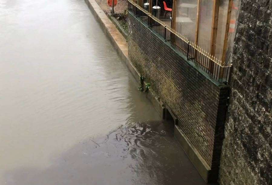 The black liquid spilling into the River Medway is believed to be drain outflow, the Environment Agency said