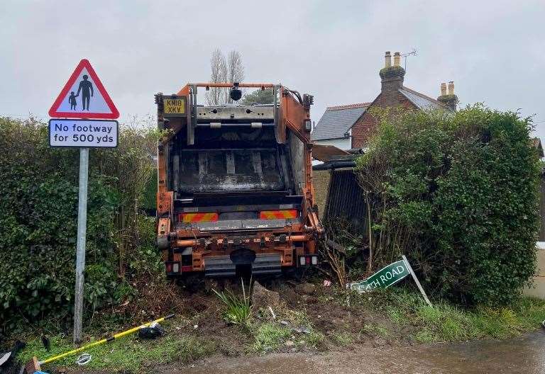 Woman taken to hospital after bin lorry ploughs through sign and into bush 