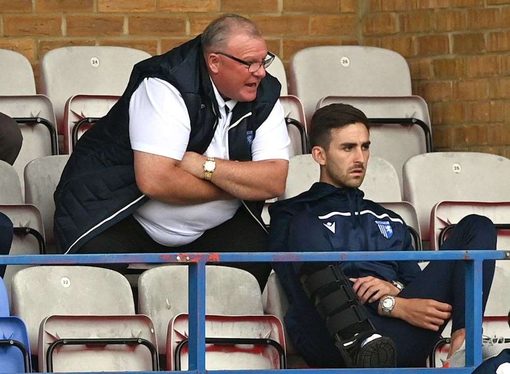 Manager Steve Evans watches Saturday's game with injured player Robbie McKenzie Picture: Keith Gillard