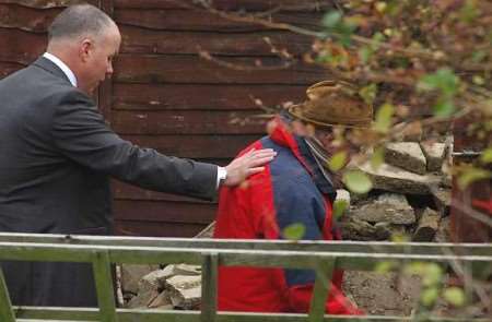 Det Supt Tim Wills offers a sympathetic hand to Ian McNicol in the garden at 50 Irvine Drive. Pictures: NICK EVANS