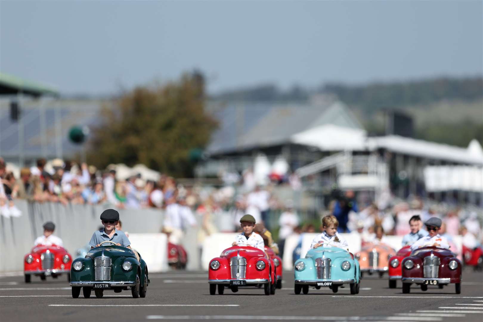 Young racers in flat caps compete in the Settrington Cup – dubbed the ‘world’s cutest race’ – at the Goodwood Motor Circuit in West Sussex in September (PA)