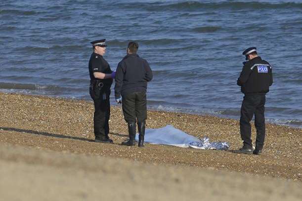 Police investigate where the body was found on the beach
