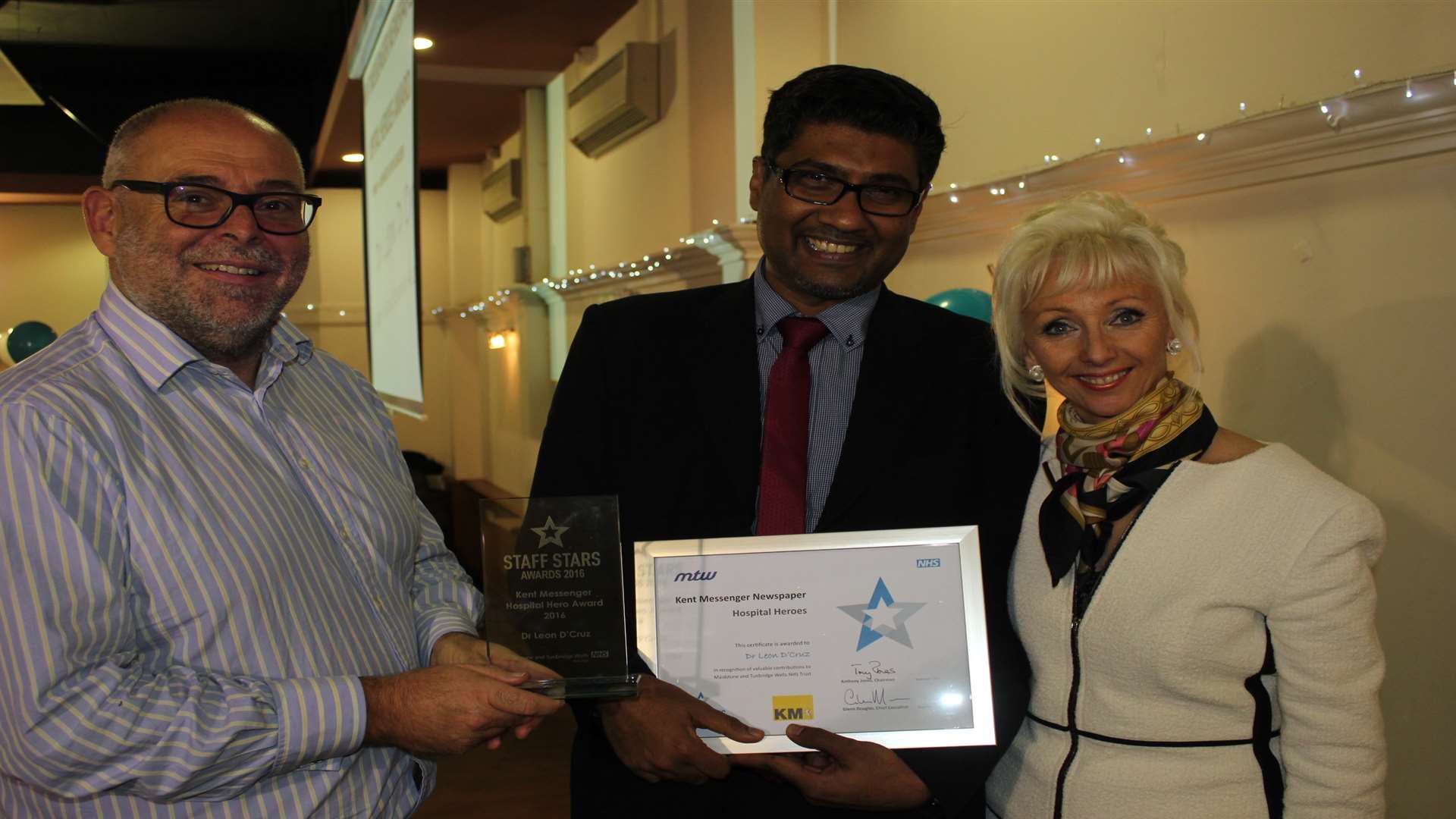 Dr Leon d'Cruz (centre) was named Hospital Hero 2017 and received his award from Maidstone and Tunbridge Wells NHS Trust chief executive Glenn Douglas and TV personality Debbie McGee
