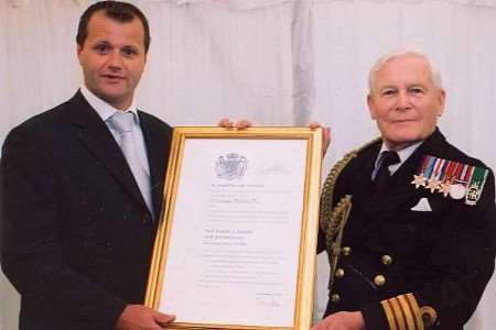 Steve Holmes, managing director of Viewframe Pictures, receives a Queen's Award for enterprise from Captain Malcolm Naylor, Deputy Lieutenant of Greater London