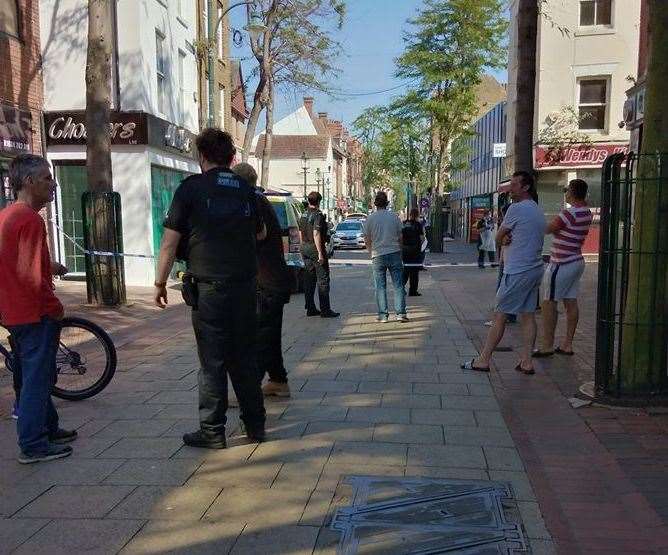 Police stand guard around a cordon in Chatham High Street. Picture:UKNiP