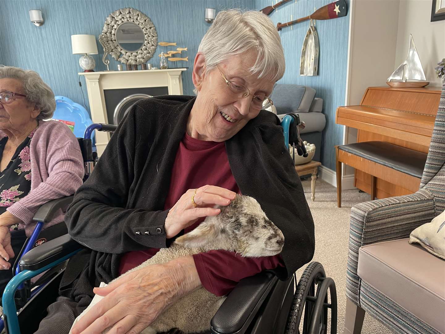 Residents got to cuddle the lambs at the care home in Whitstable. Picture: Harrier Lodge