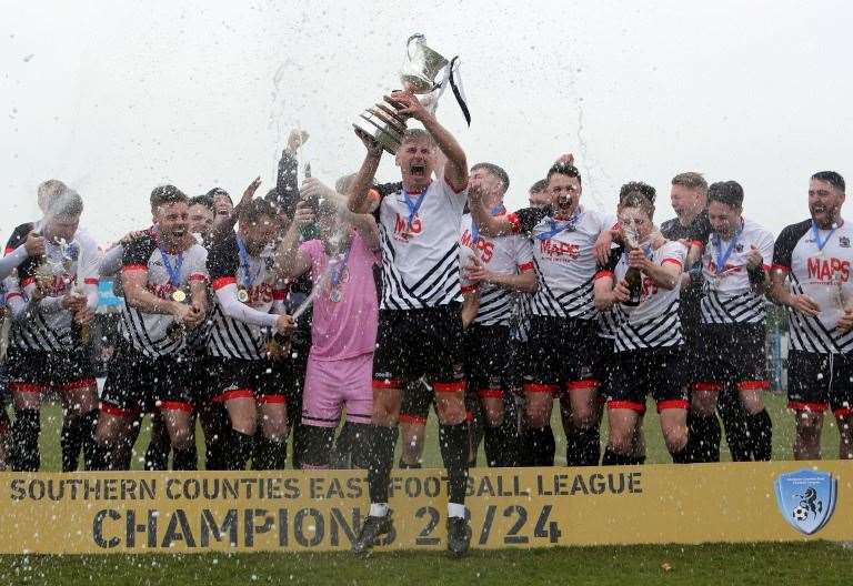 Deal club captain Kane Smith lifts the trophy for the champions. Picture: Paul Willmott