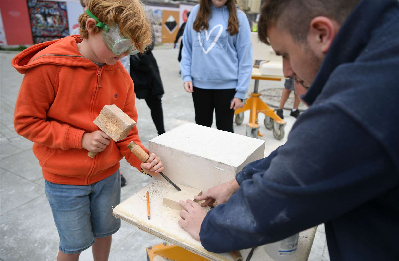 Mason Jordan Cliffe helps a youngster have a go at Canterbury Cathedral