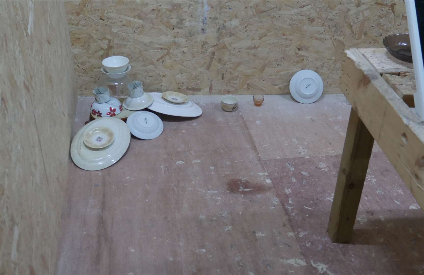 Mugs and plates were put in the corner of the rage room