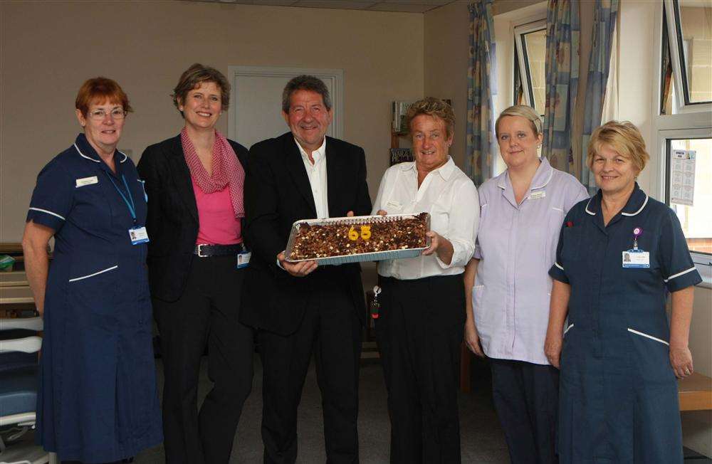 Gordon Henderson presents a cake to the nurses to celebrate the 65th anniversary of the NHS