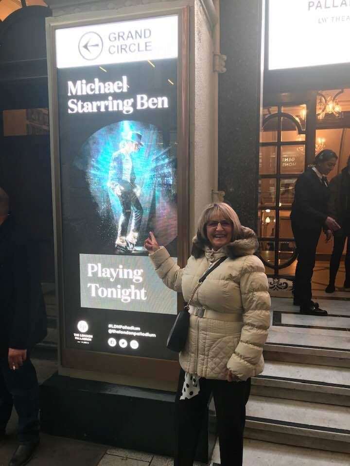 Ben Bowman's proud mum Anita Bowman with a poster of her son outside the London Palladium