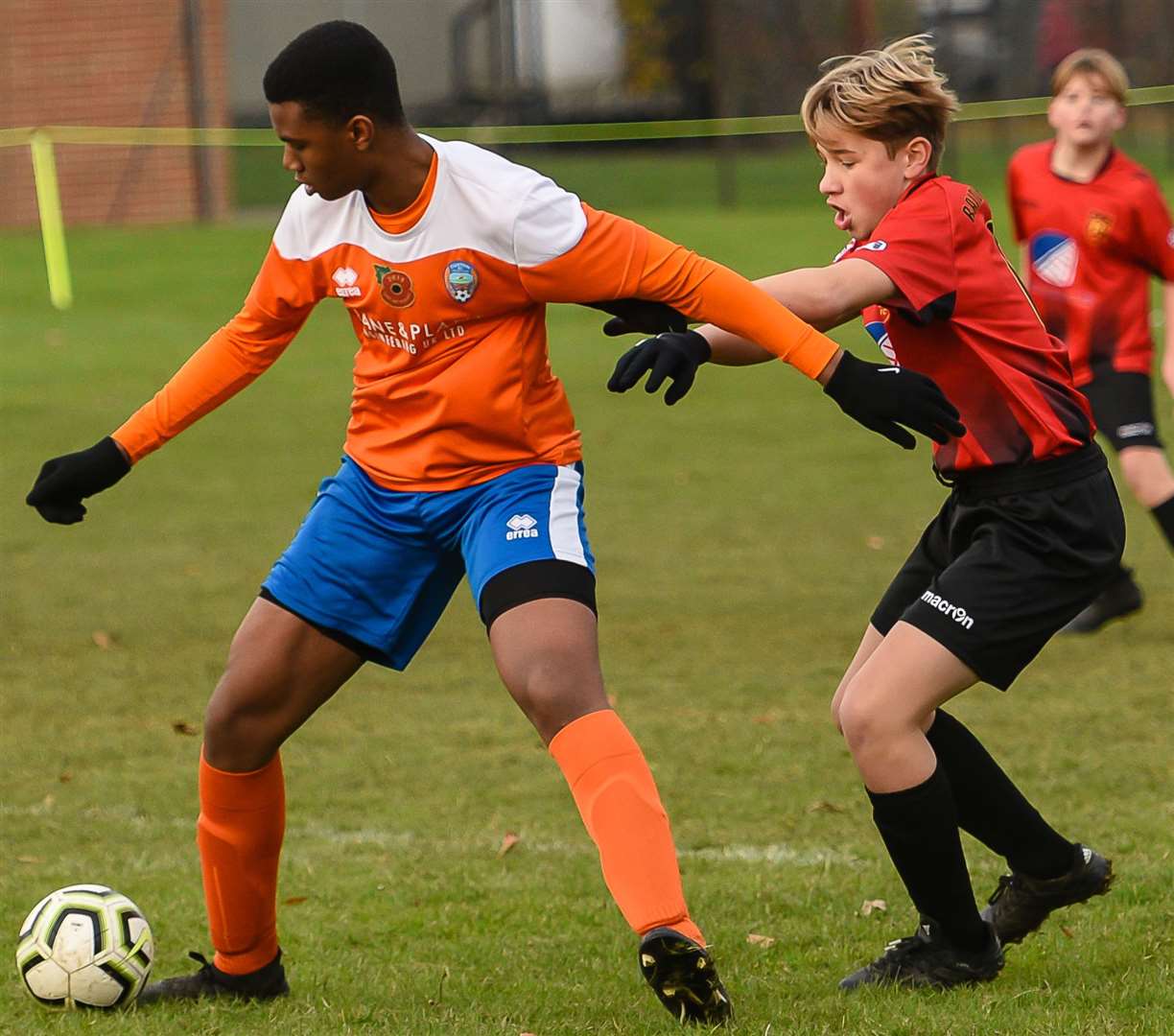 Cuxton 91 under-14s (orange) hold the ball up against Rainham 84 Rangers under-14s. Picture: Alan Langley FM21837896