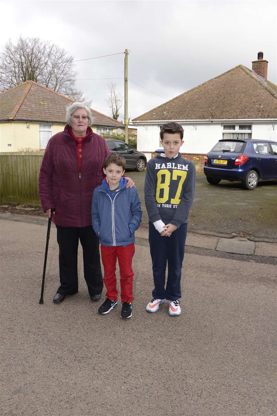 Sally Chamberlain and grandchildren Mason, 9, and Blake, 7, outside her Singledge Lane home where roundabouts are planned to service new development in the field opposite