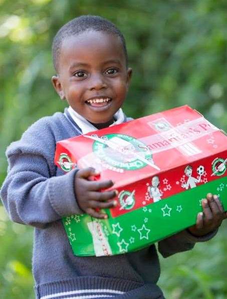 A schoolboy with a shoebox from Operation Christmas Child. Picture: Samaritan's Purse