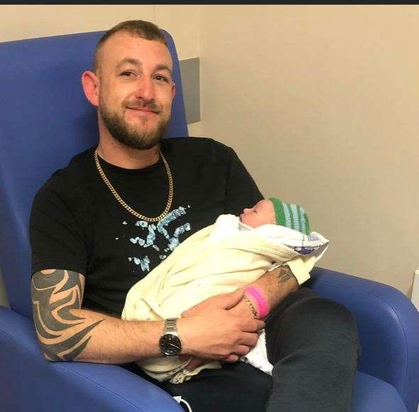 Proud dad Michael Munday holding his youngest child Matthew on the day he was born