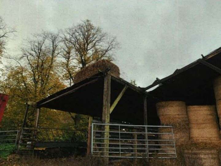 A hay bale was used to secure the roof on one shed
