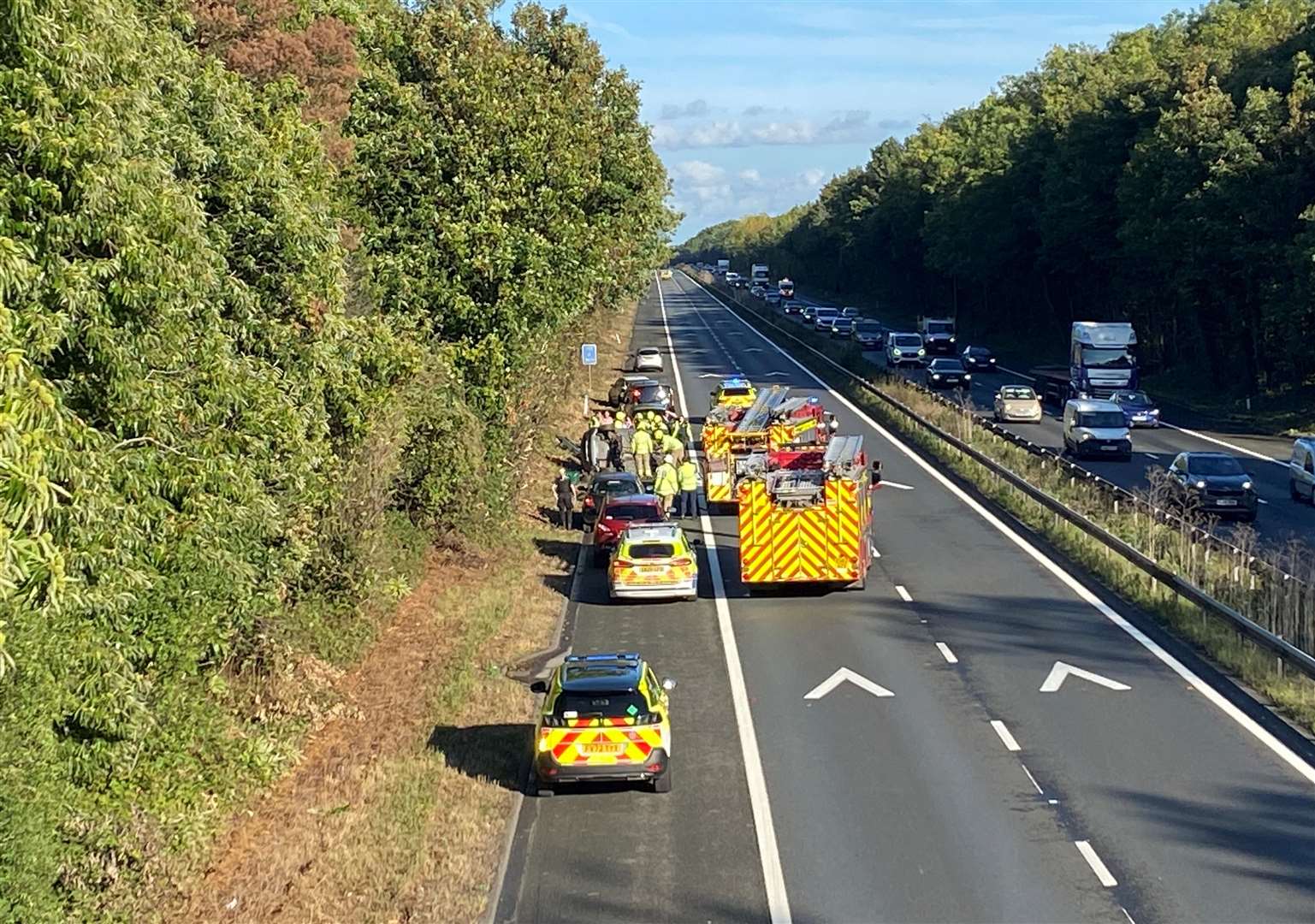 Traffic has been stopped on the M2 near Faversham after a collision left a car on its side