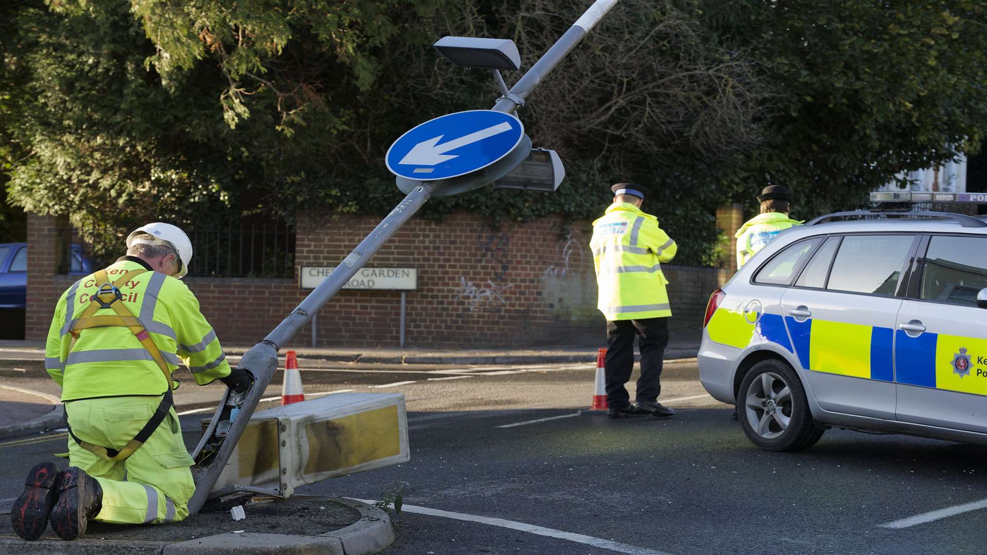 A workman from KCC works to disconnect a lamp standard damaged in the crash