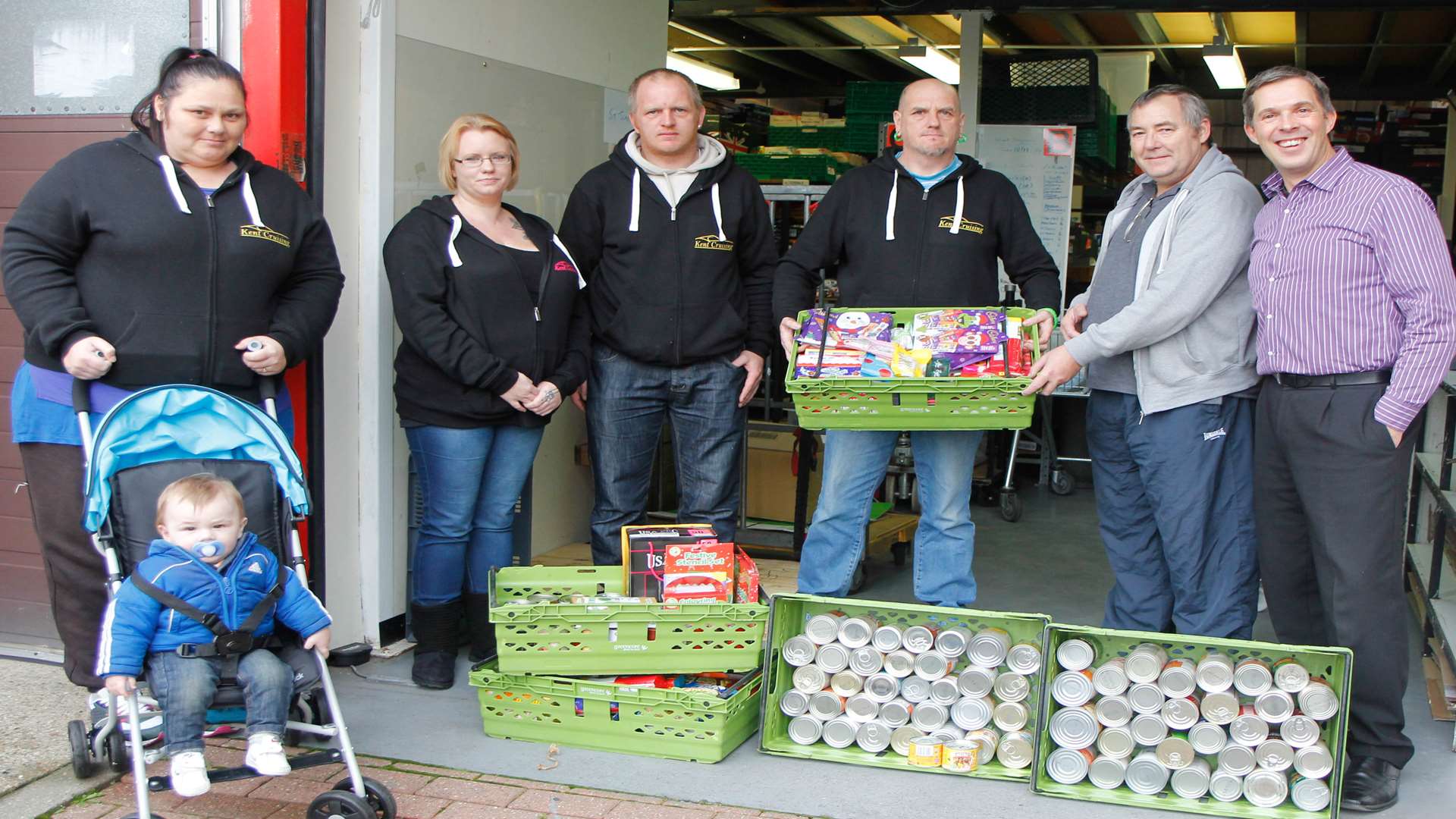 People handing lots of donated food to the foodbank. Left to Right: Kent Cruisings's Louise Arthur, Gemma Wyatt, Michael Elsey and Kevin Lindley with Medway Food Bank's Ken Rose and Project Manager Ian Childs